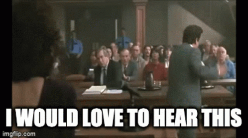 a gif of Vinny from the film My Cousing Vinny sitting on a desk saying I'd love to hear this