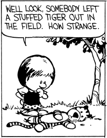 Susie stands over Hobbes and says 'Well look, somebody left a stuffed tiger out in the field. How strange.'