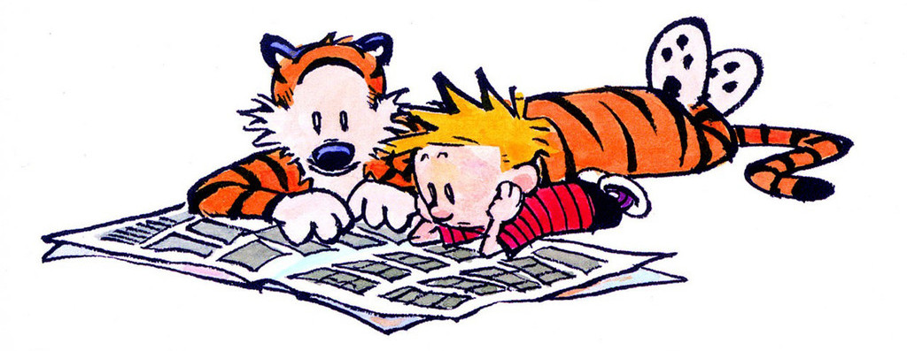 Calvin and Hobbes laying on the floor reading a newspaper